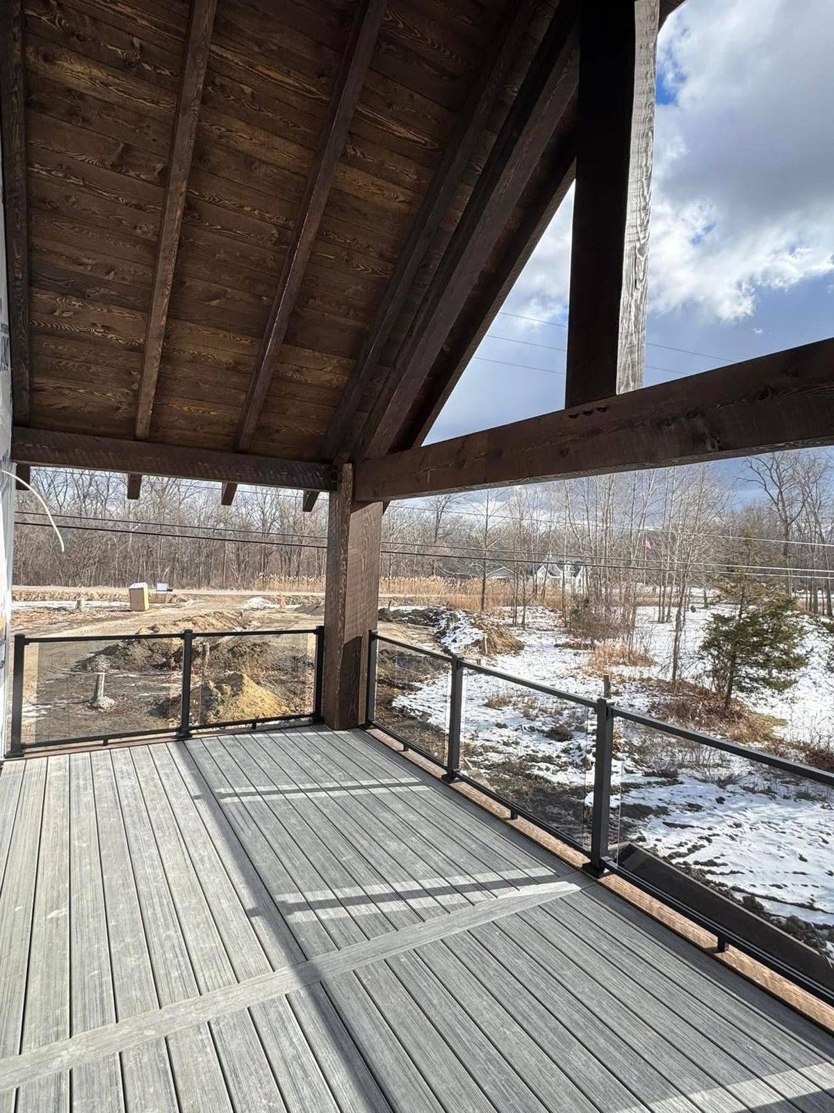 Covered deck with glass and black metal railing