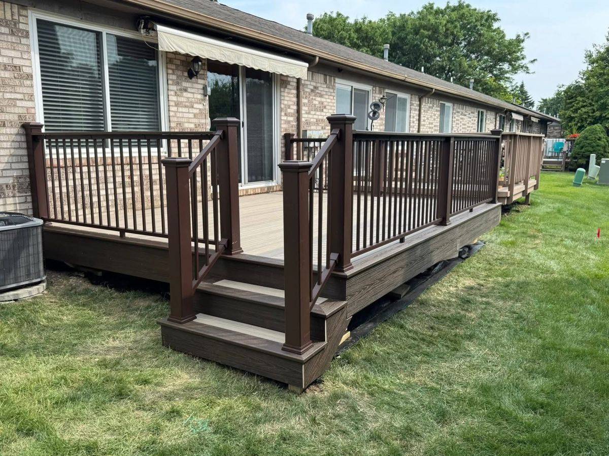 Long composite deck with dark brown railings