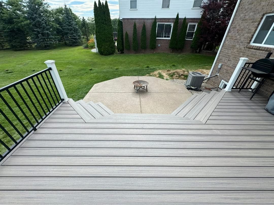 Deck overlooking backyard patio and fire pit