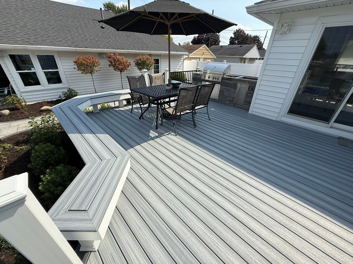 Second story deck with lit staircase at dusk